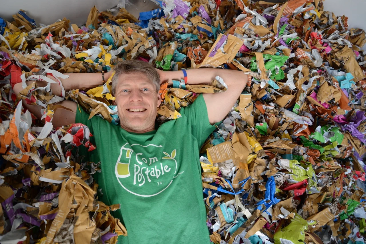 Co-owner Stacey dives into a pile of shredded LGT coffee packages.