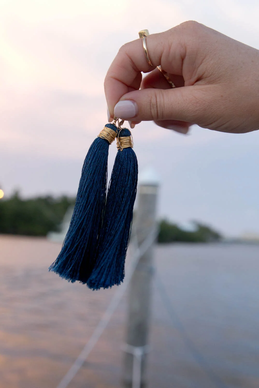 Peacock earrings held.jpg