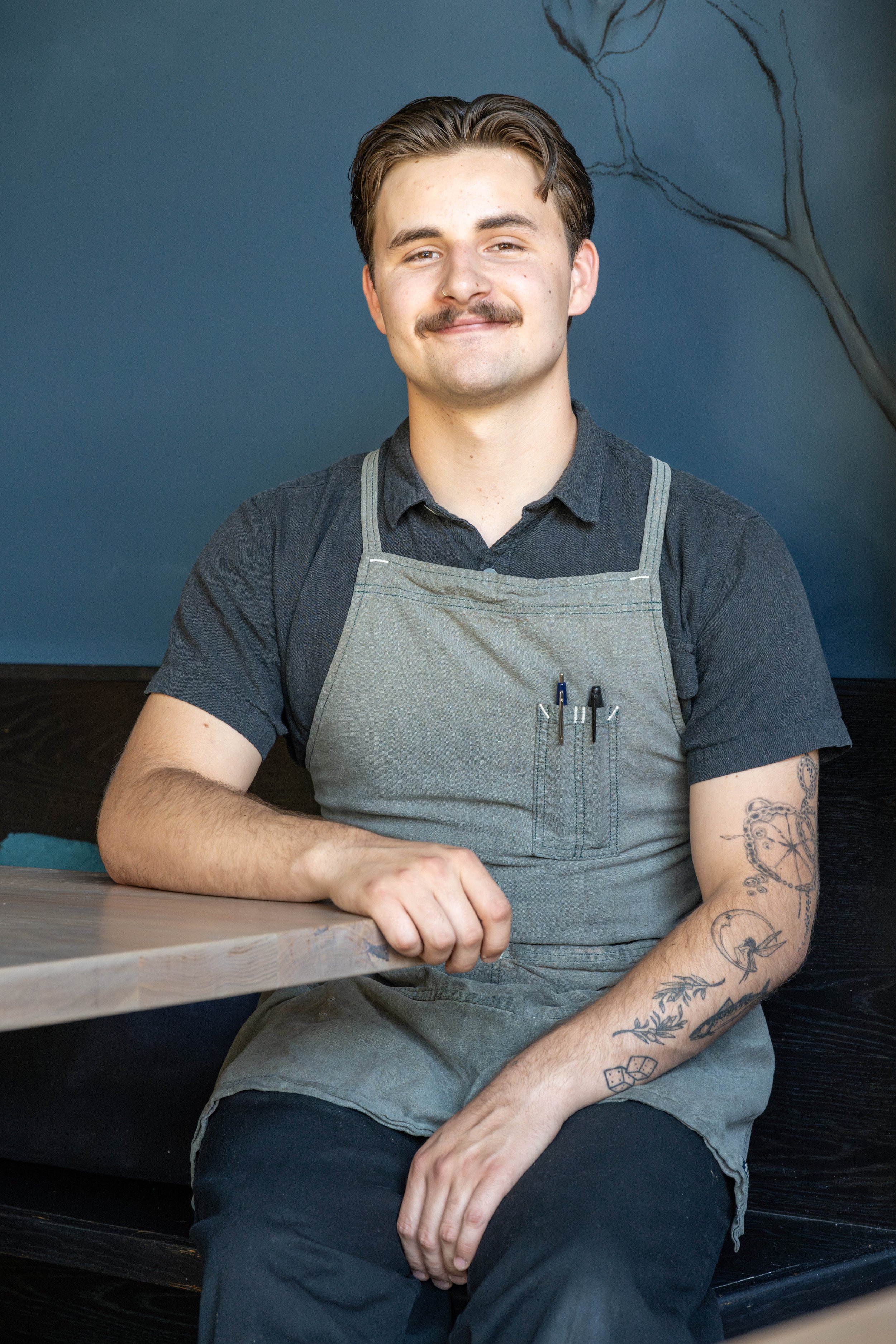 A close up headshot of Jack sitting at a table in Octavia's dining room.