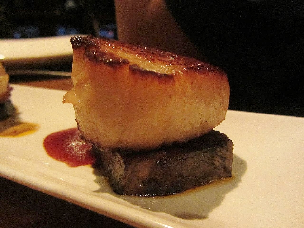 Seared scallops with braised shortrib and porcini emulsion