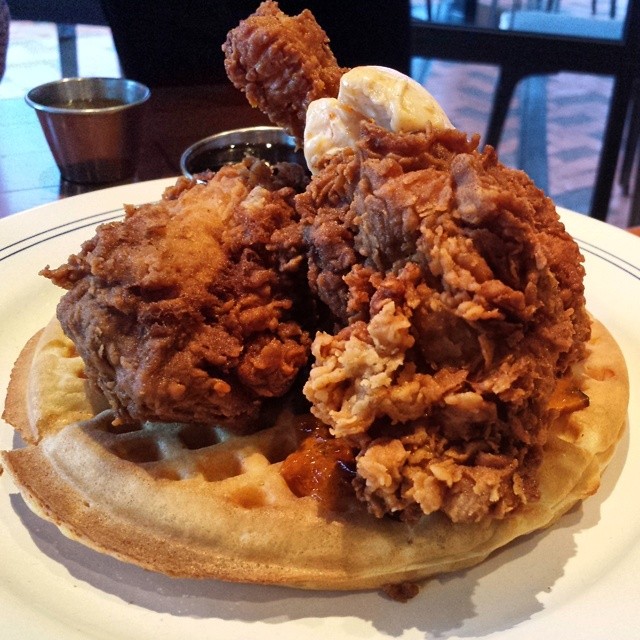Chicken and waffles with bourbon-peach syrup, cayenne maple butter, housemade jalapeno hot sauce. 
