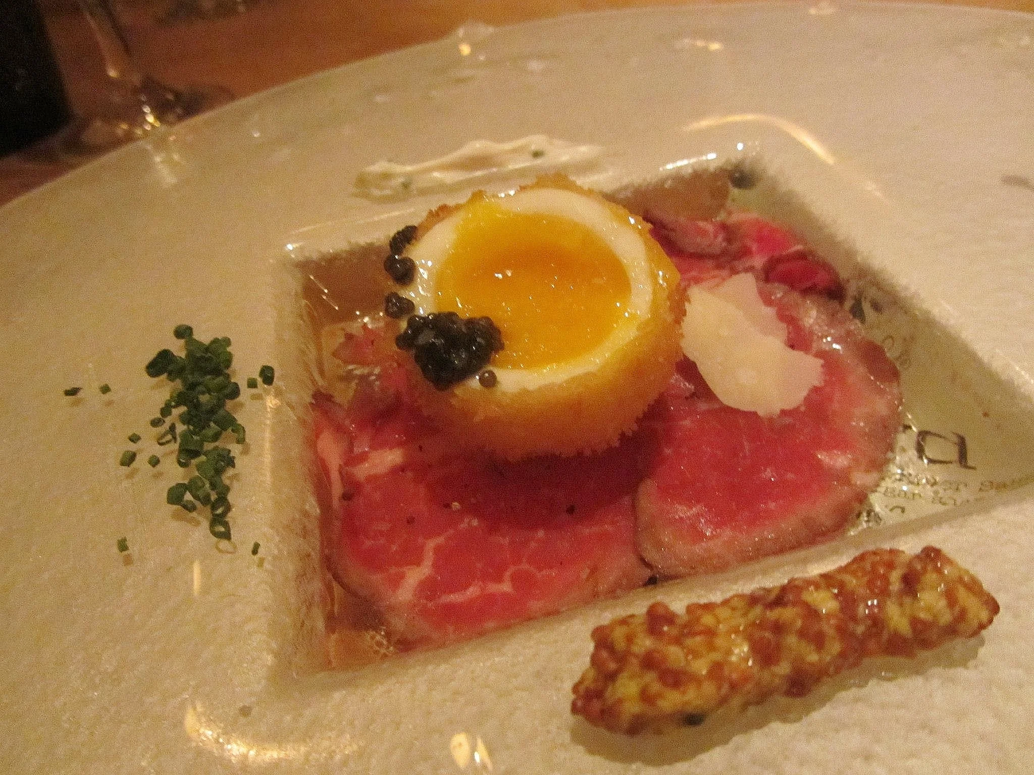 Cedar River carpaccio with caviar and a crispy egg.