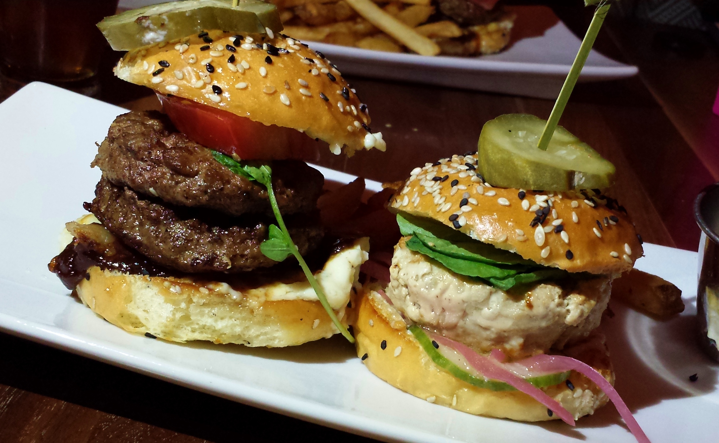 Burger Duo:  Niman Ranch double with bacon, tomato, onion jam and smoked blue cheese; tuna with pickled cucumber and onion, watercress, and mustard aioli.