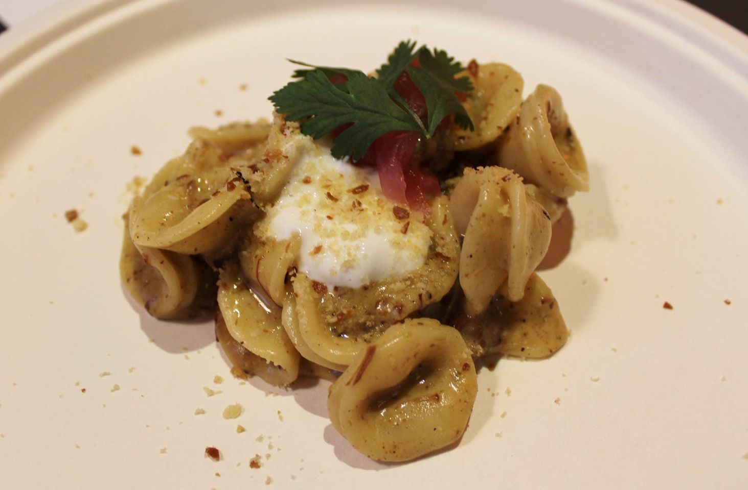 Pink Pony's orecchiette with green chili pork, beer cheese, quark, and pickled onions