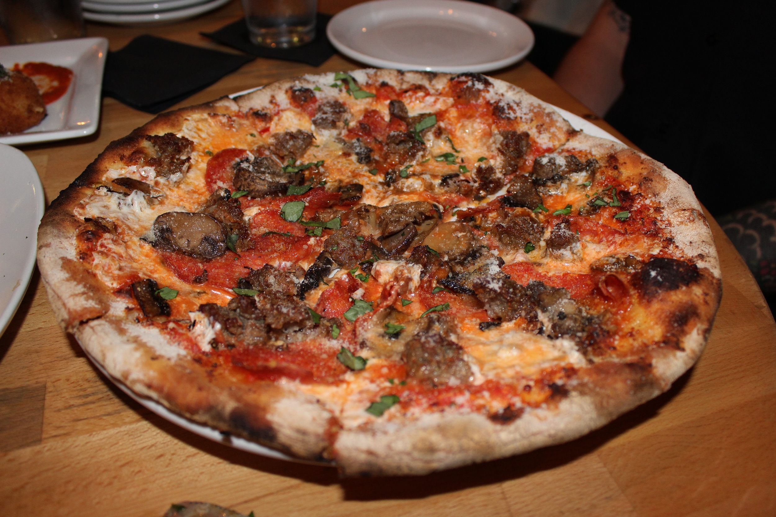 Porco e Funghi pizza (house-pulled mozzarella, parmesan, sausage, and mushrooms) + spicy soppressata