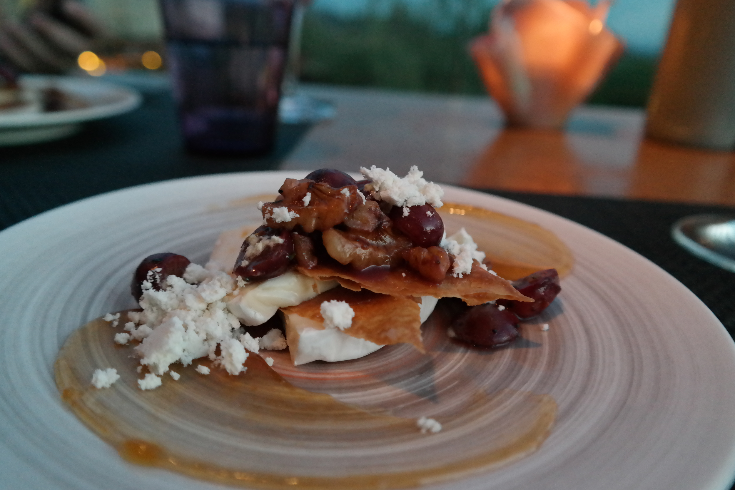 Triple creme brie Napoleon with grapes, walnuts, olive oil powder and apricot marmalade.