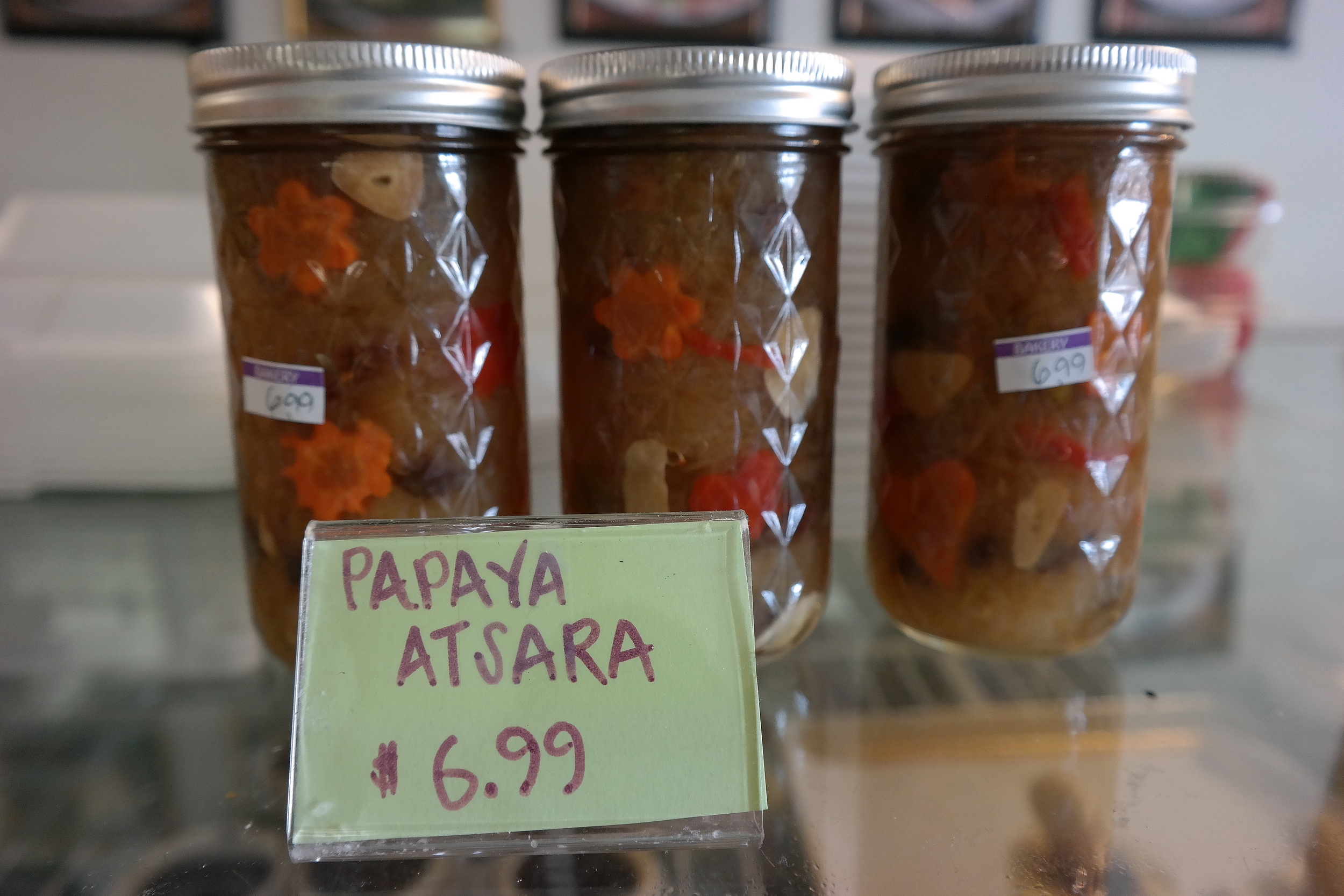 Pickled green papaya relish with peppers, garlic, carrots, and raisins