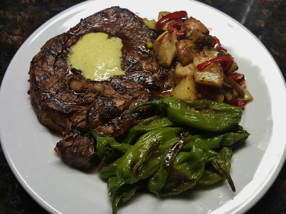 Grilled ribeye with shishito peppers and artichoke-potato hash