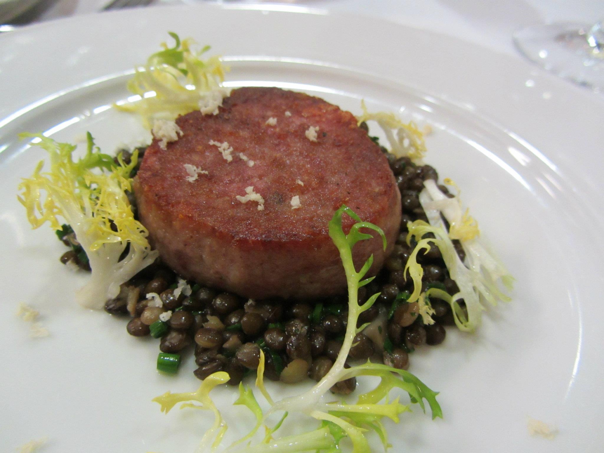 Cotechino with frisee and black lentils