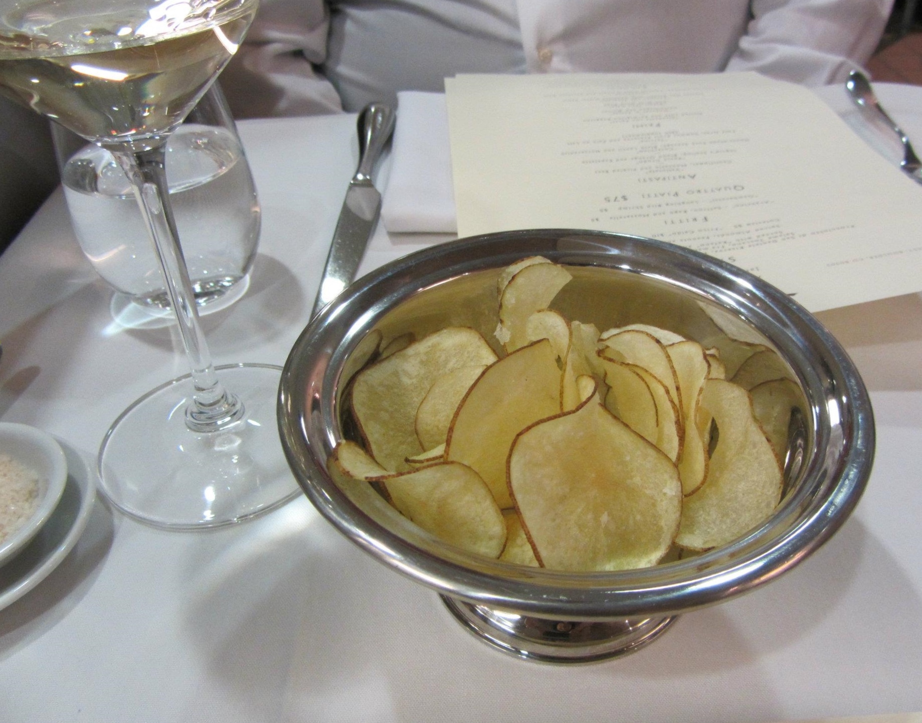 A traditional tajut of complimentary Friuli white wine and fresh chips