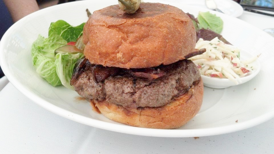 Lon's Signature Burger with local goat cheese, house bacon, caramelized onions, and chipotle aioli