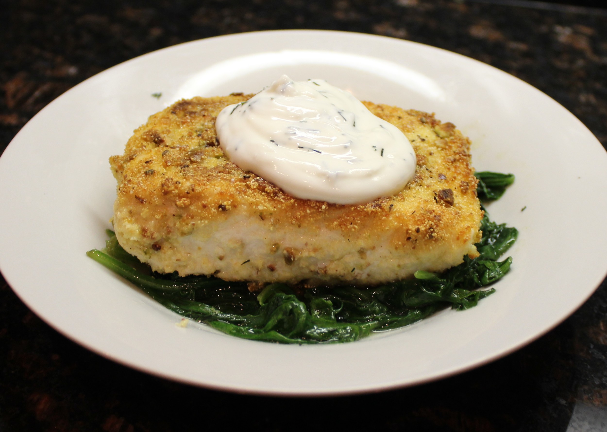 Pistachio-crusted halibut with yogurt-dill sauce and sauteed spinach