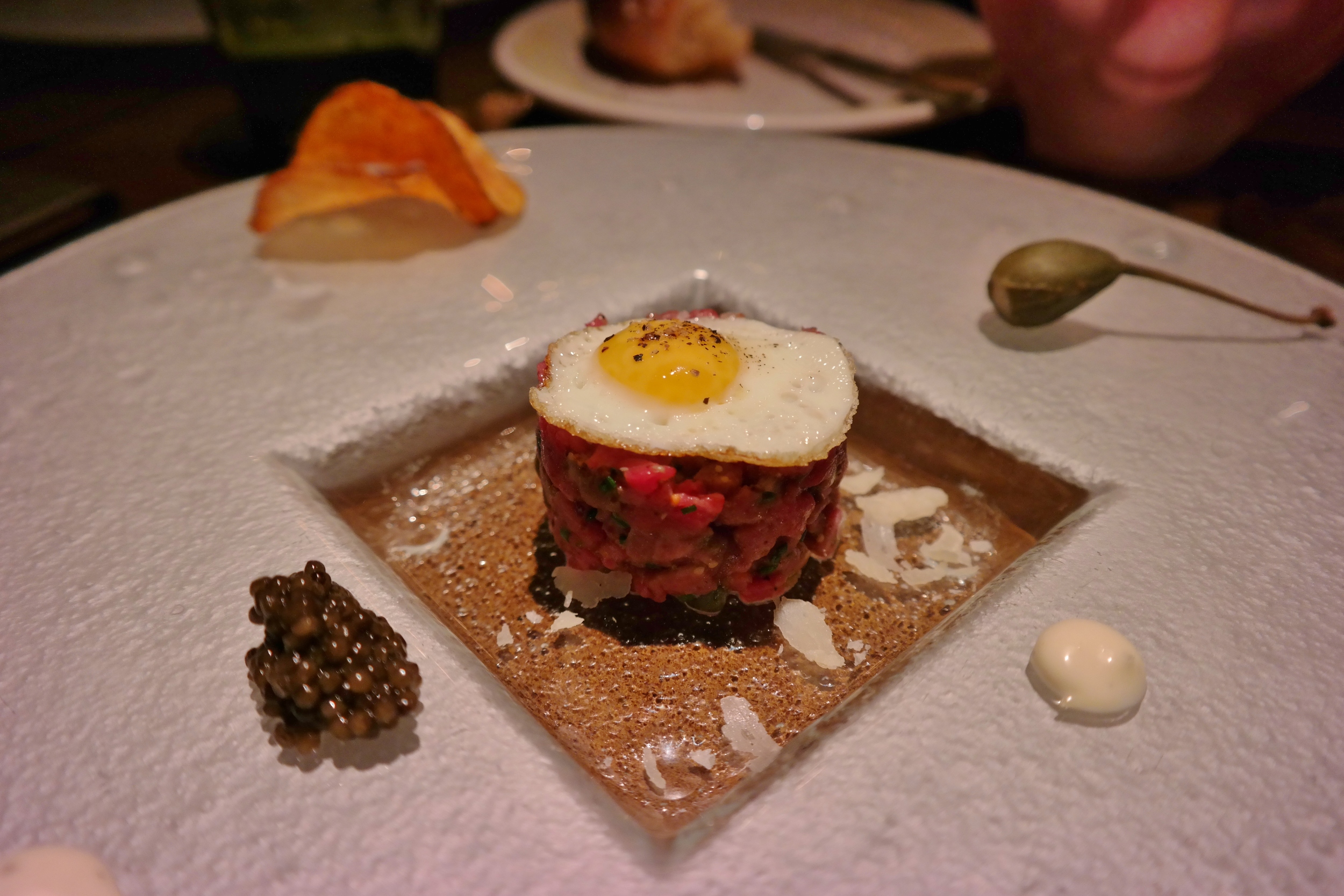 Tartare with quail egg, caviar, and caper berry