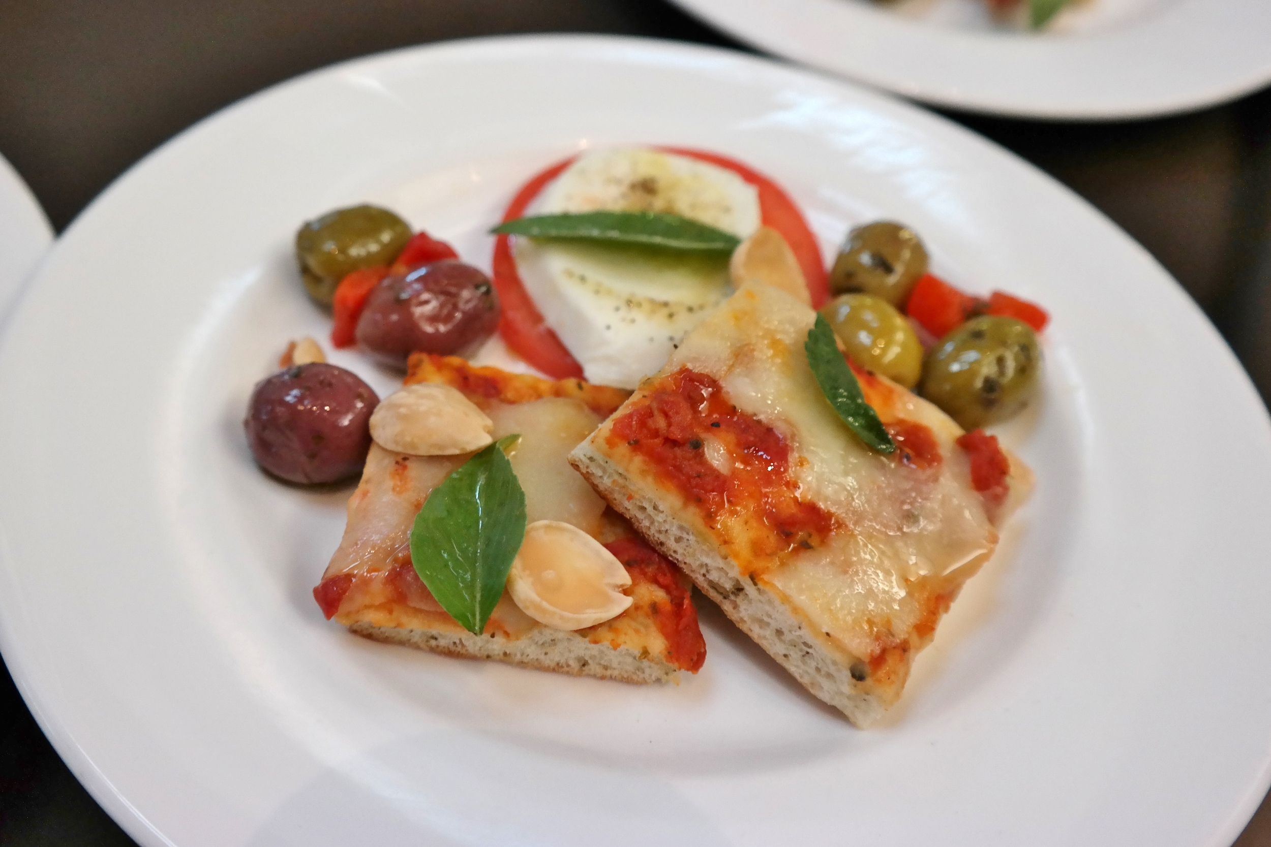 Flatbread with olives, almonds, and Caprese.