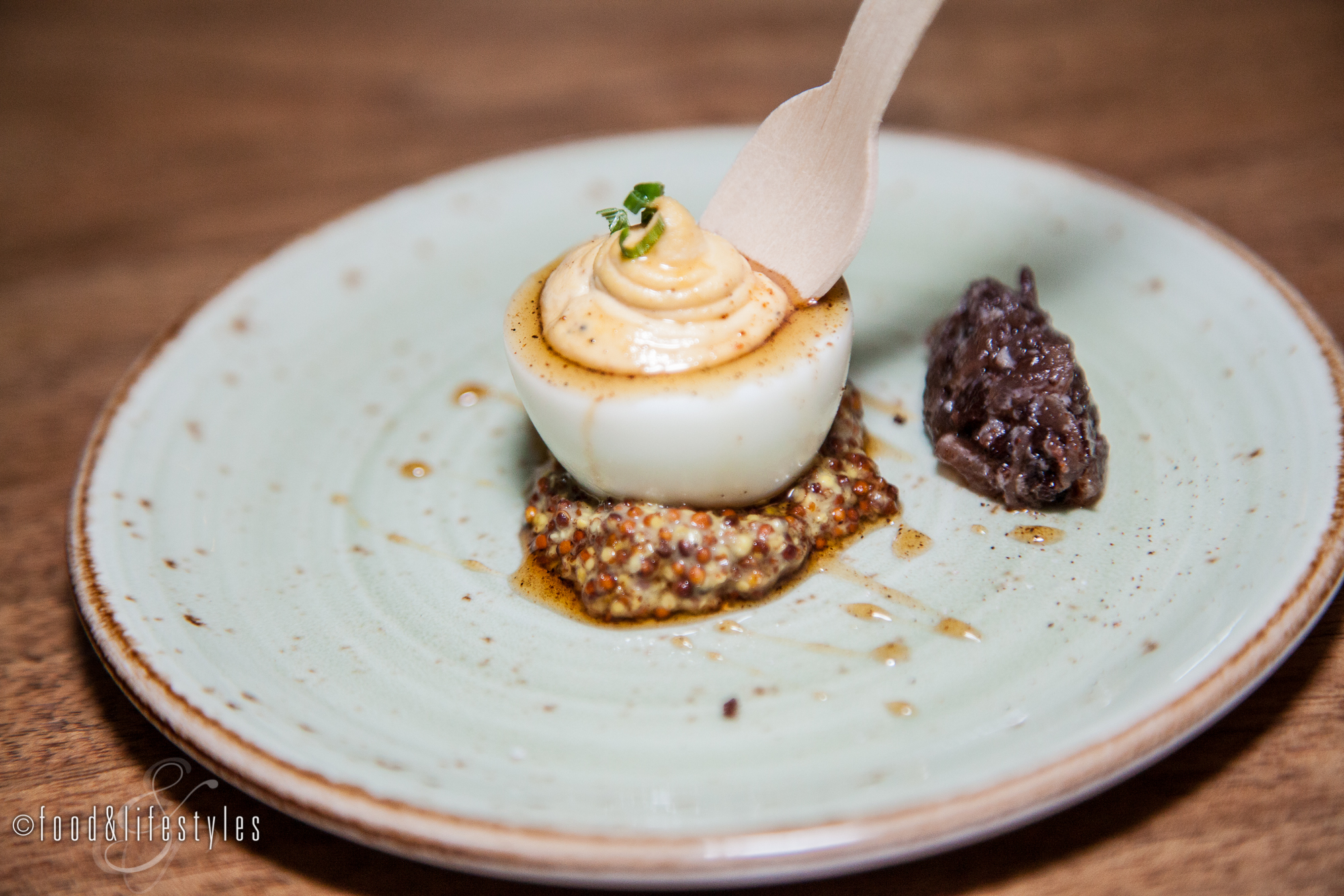 Deviled egg with pasilla-maple syrup, bacon-onion marmalade and grain mustard