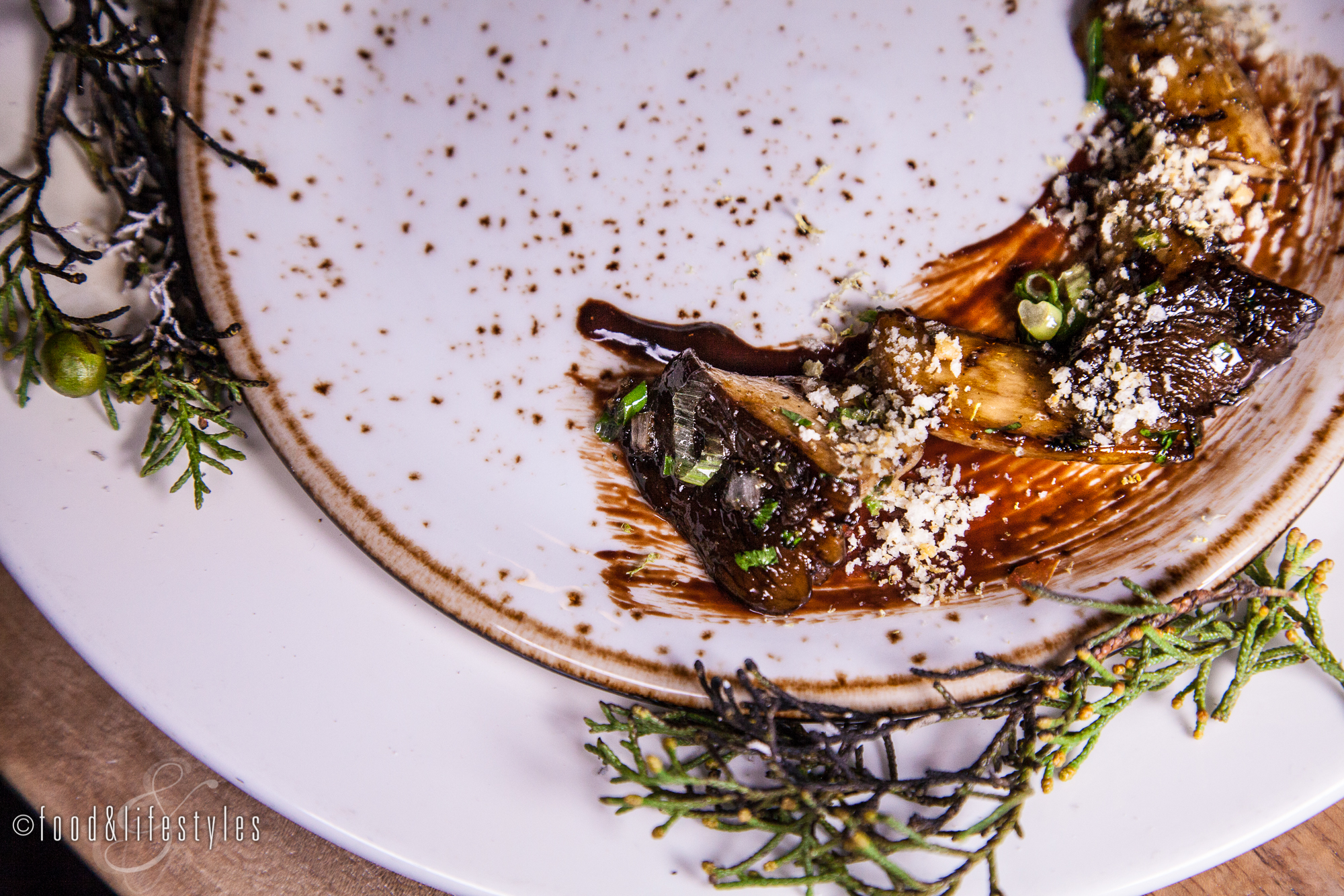 Wild mushrooms with smoked pine needles, pine nut gremolata, and Mexican chocolate
