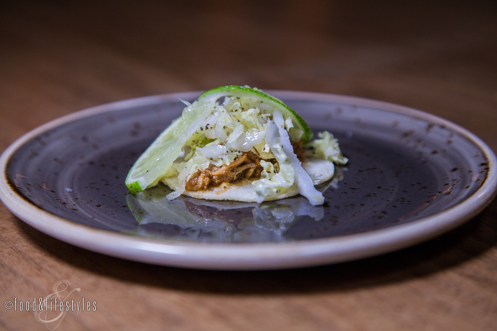 Duck confit tacos with eggplant mole, guacamole, and napa cabbage