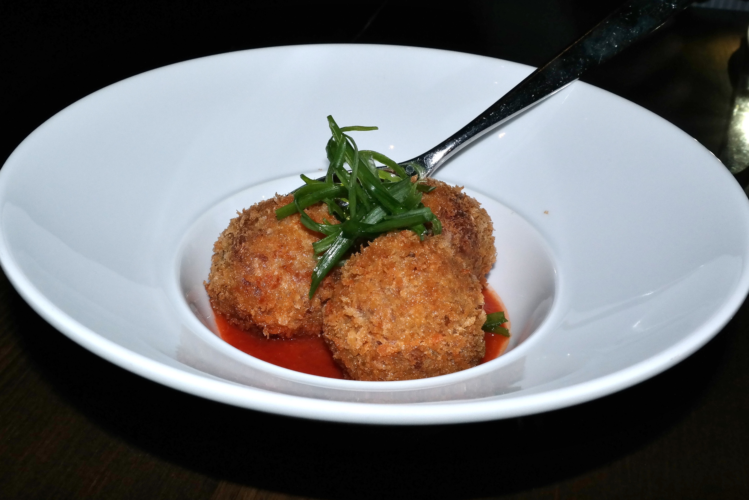 Boudin balls with tomato jam and green onion