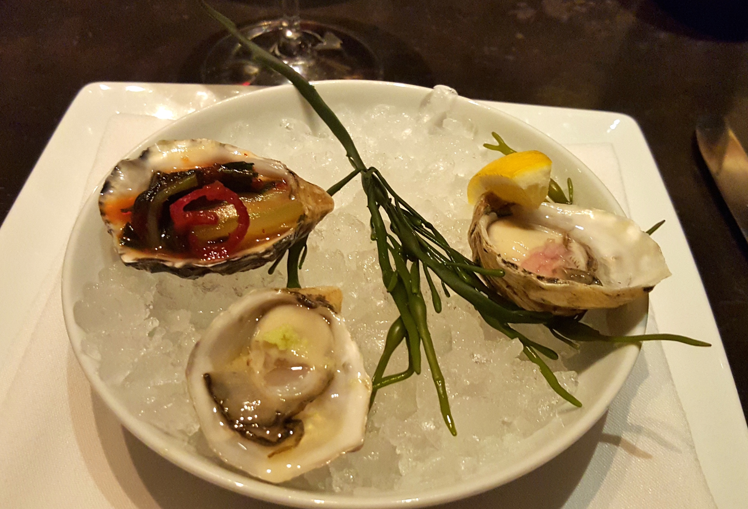 Oyster trio with kimchi, mignonette, and ponzu with wasabi 