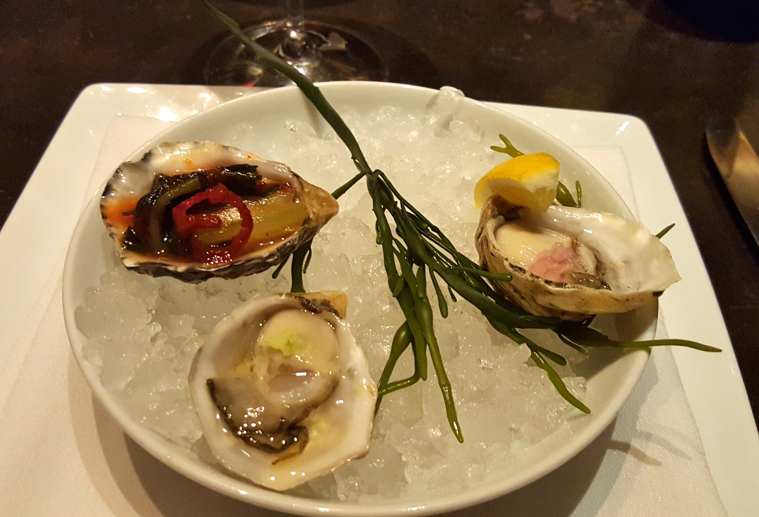Oyster trio with kimchi, mignonette, and ponzu with wasabi