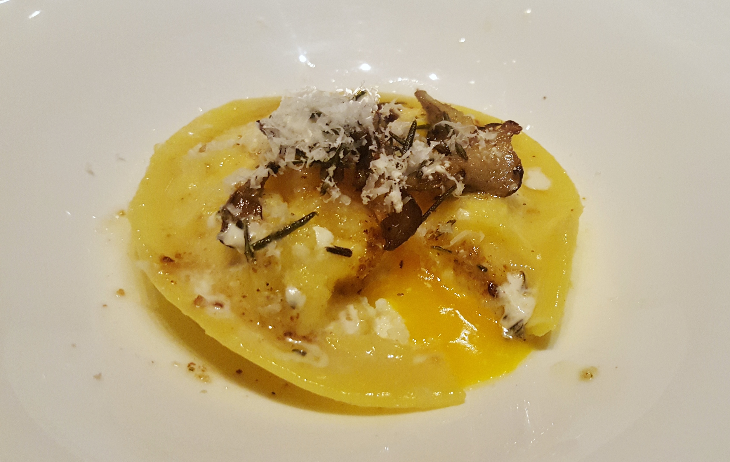Egg raviolo with ricotta, maitake mushrooms, parmesan, and brown butter