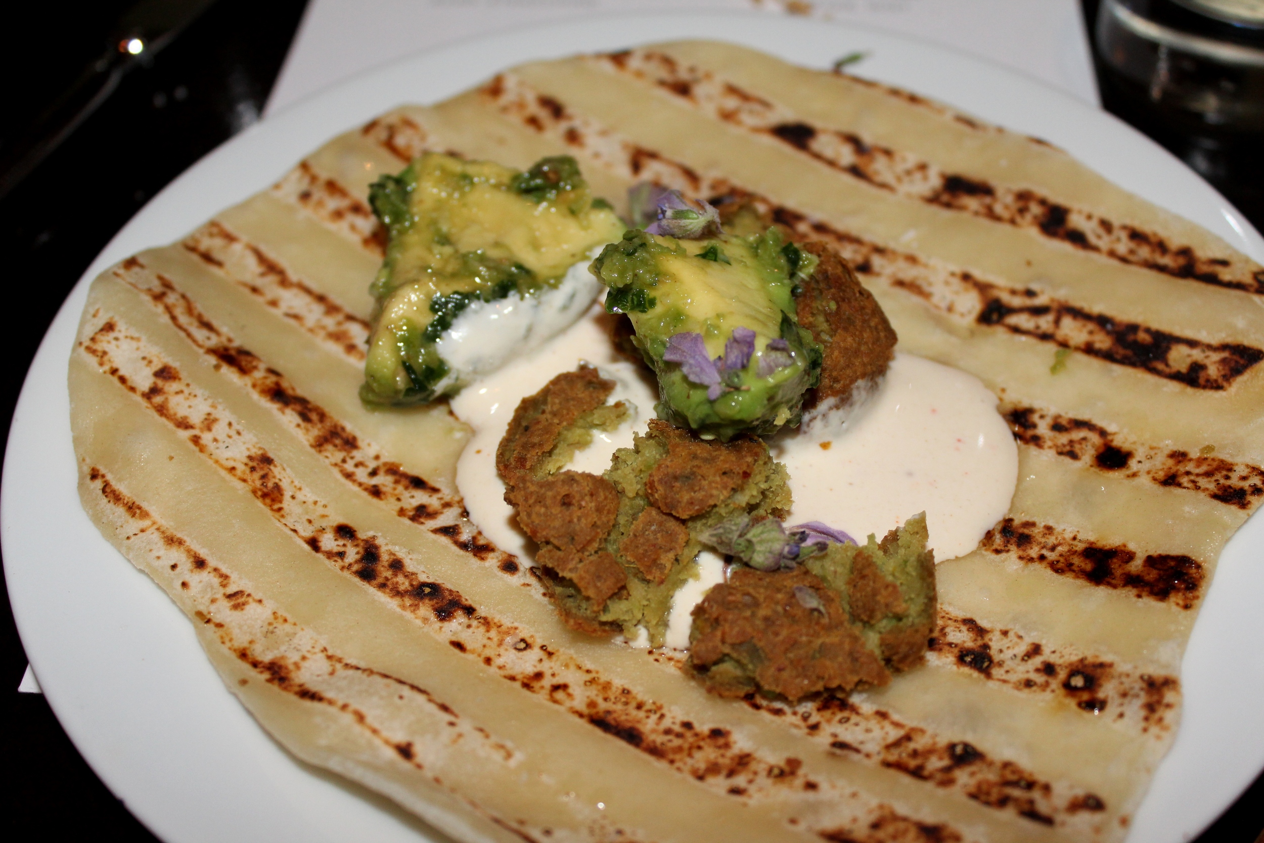 Fava bean falafel with labneh, avocado, and spicy Yemenite schug