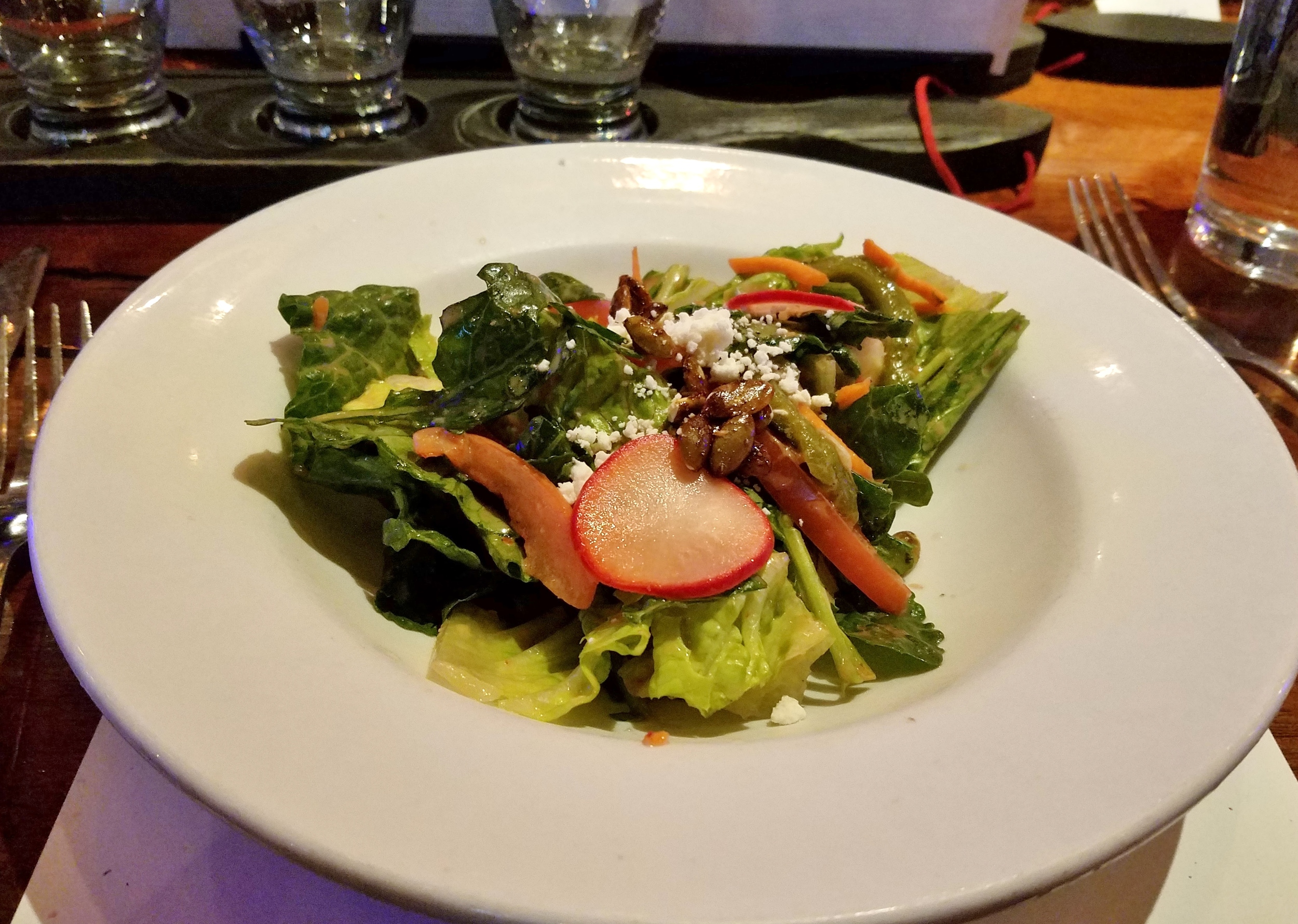 Salad with spicy pumpkin seed brittle, queso fresco, pickled radishes, and blood orange vinaigrette