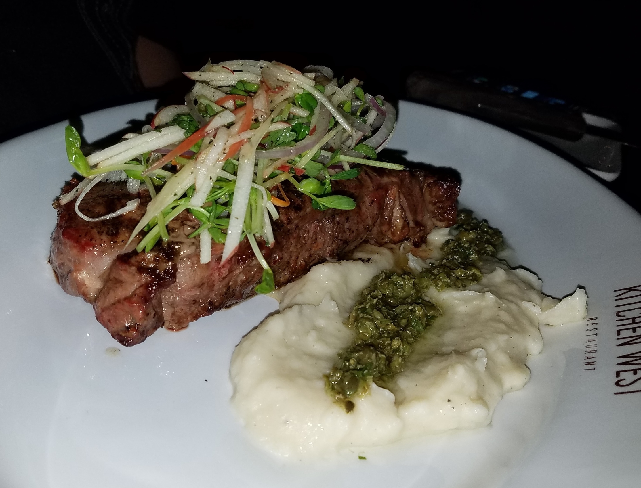 Grilled New York strip with slaw, cilantro chimichurri, and garlic mash