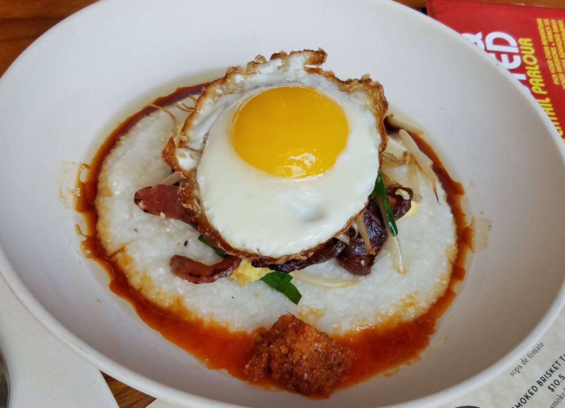 "Grits & Eggs" with Chinese sausage, garlic chives, bean sprouts, soy, Homeboy's Hot Sauce, sesame shallot oil, homemade bagoong