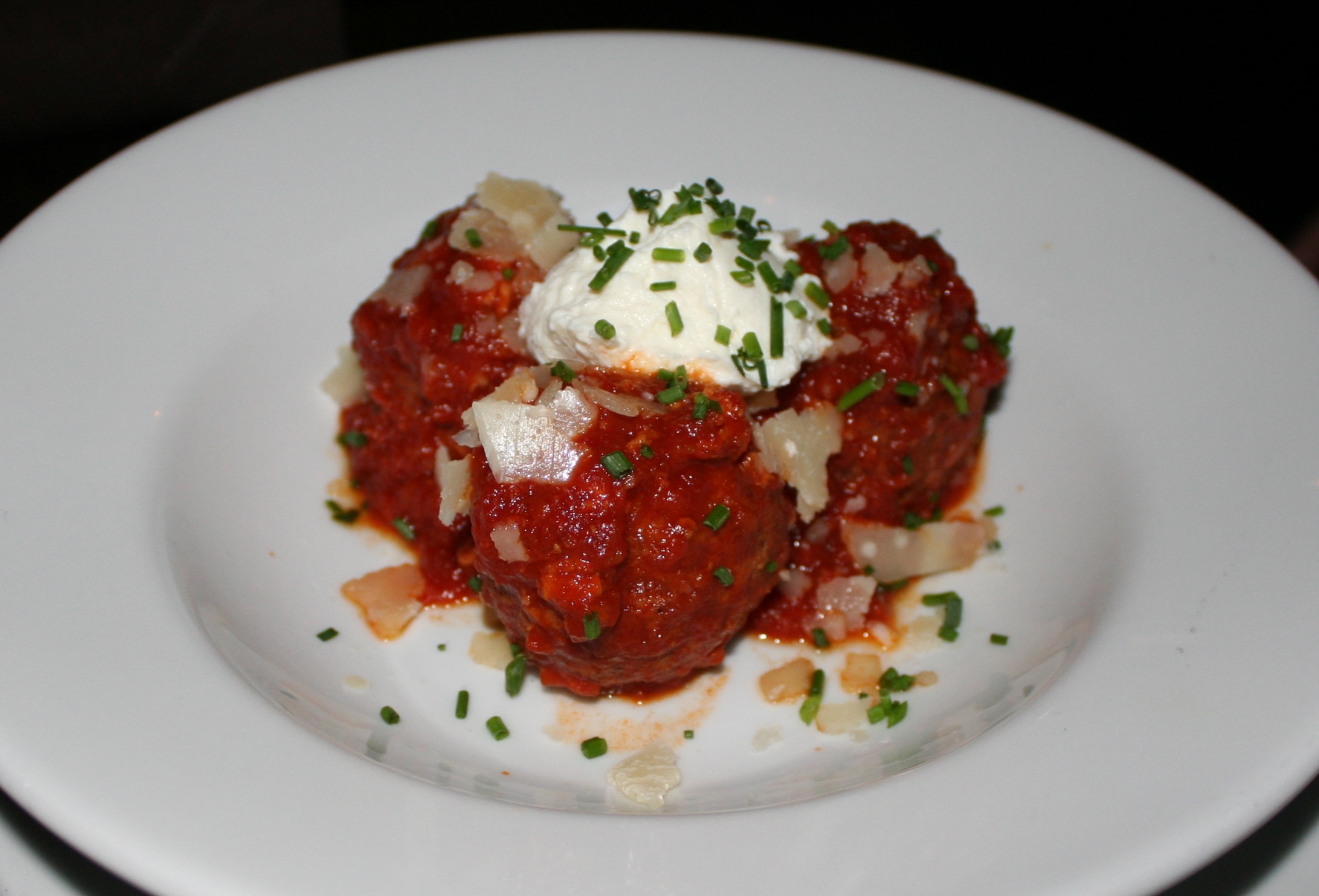 Pork meatballs with ground pork, prosciutto and mortadella with pomodoro sauce and whipped ricotta