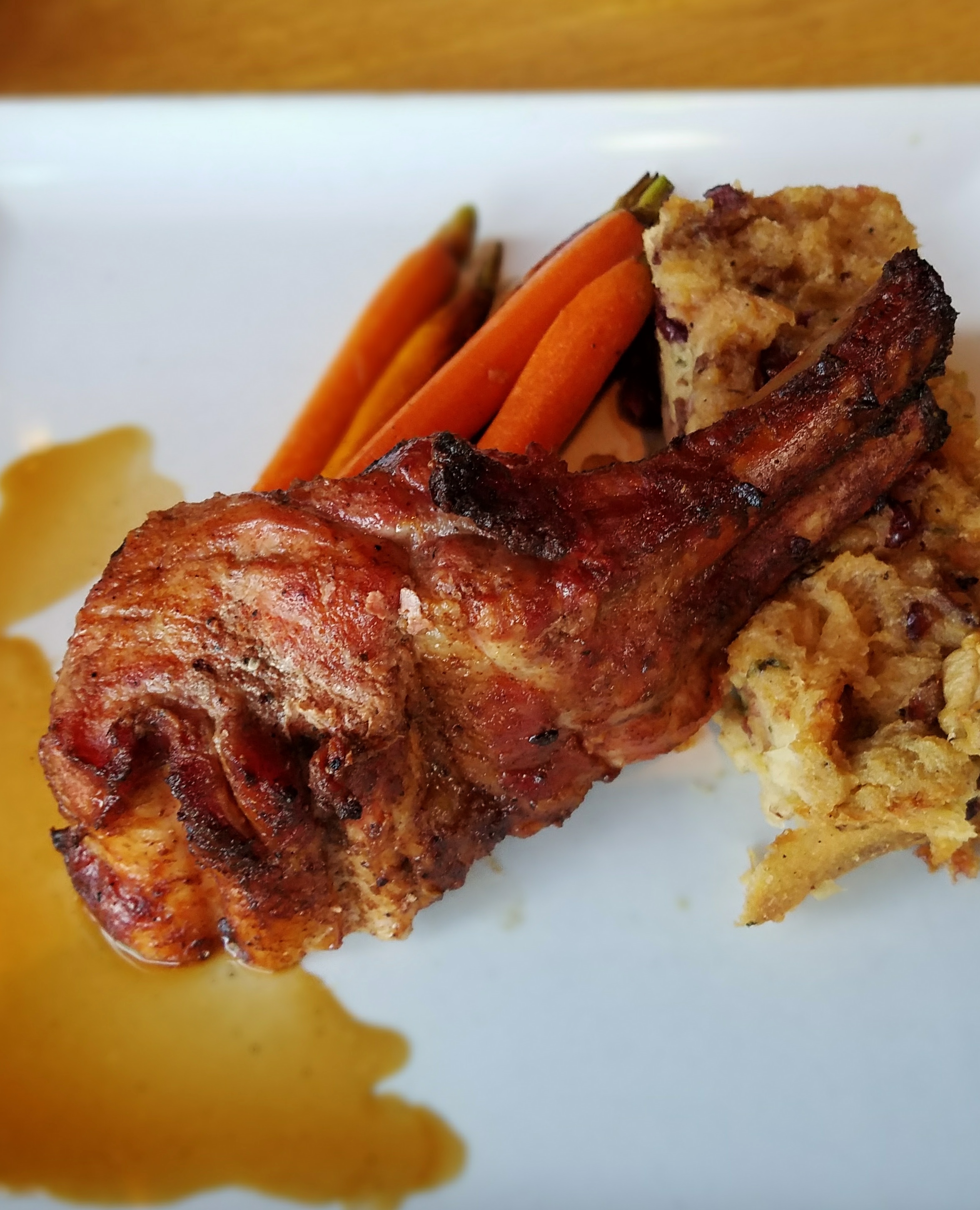 Rotisserie pork chop with apple bread pudding