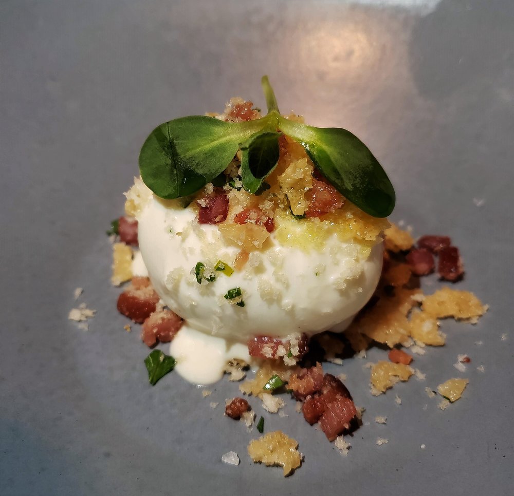 Poached egg with caviar creme fraiche and house-cured pancetta crumble