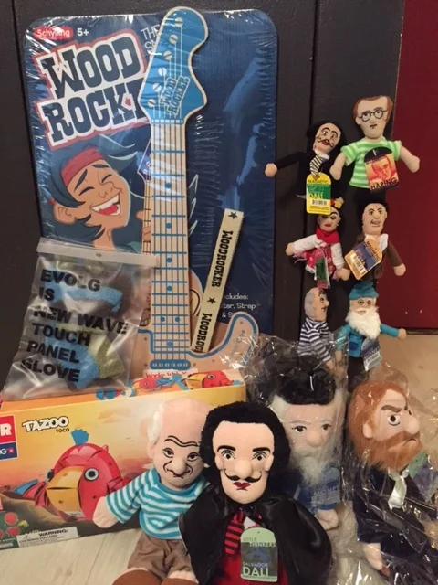 Clockwise from Top Left: Wood Rocker, Magnetic Artist Finger Puppets and Plush Dolls, what I believe are called Tazoo magnetic blocks (?) , and Evolg Three finger mittens.