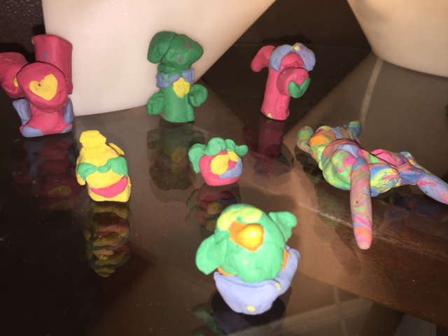 Some of the modeling clay Pokemon Zephyr and Lyric have been making. I'm not sure on the names, but they all have 'em. The one in the front is a bird of some kind, and the rainbow one that kind of looks like a Cronenbergian ear mite was made by Lyric.