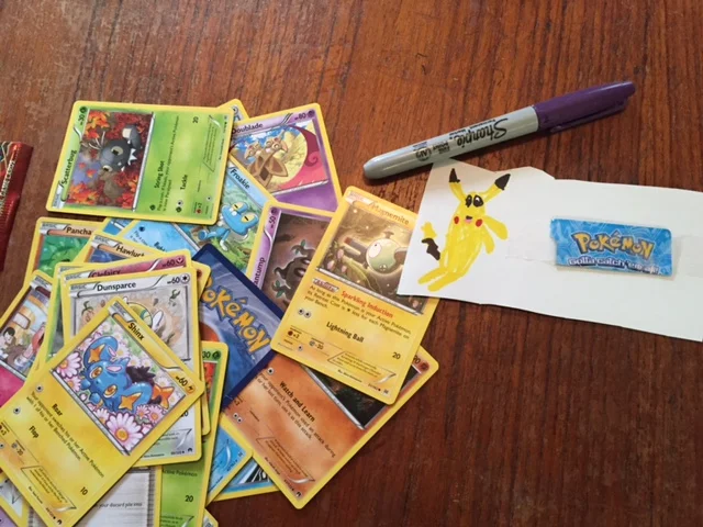 Meanwhile, Zephyr drew his own Pikachu, and is making "Pokémon Station" signs for something he's working on...