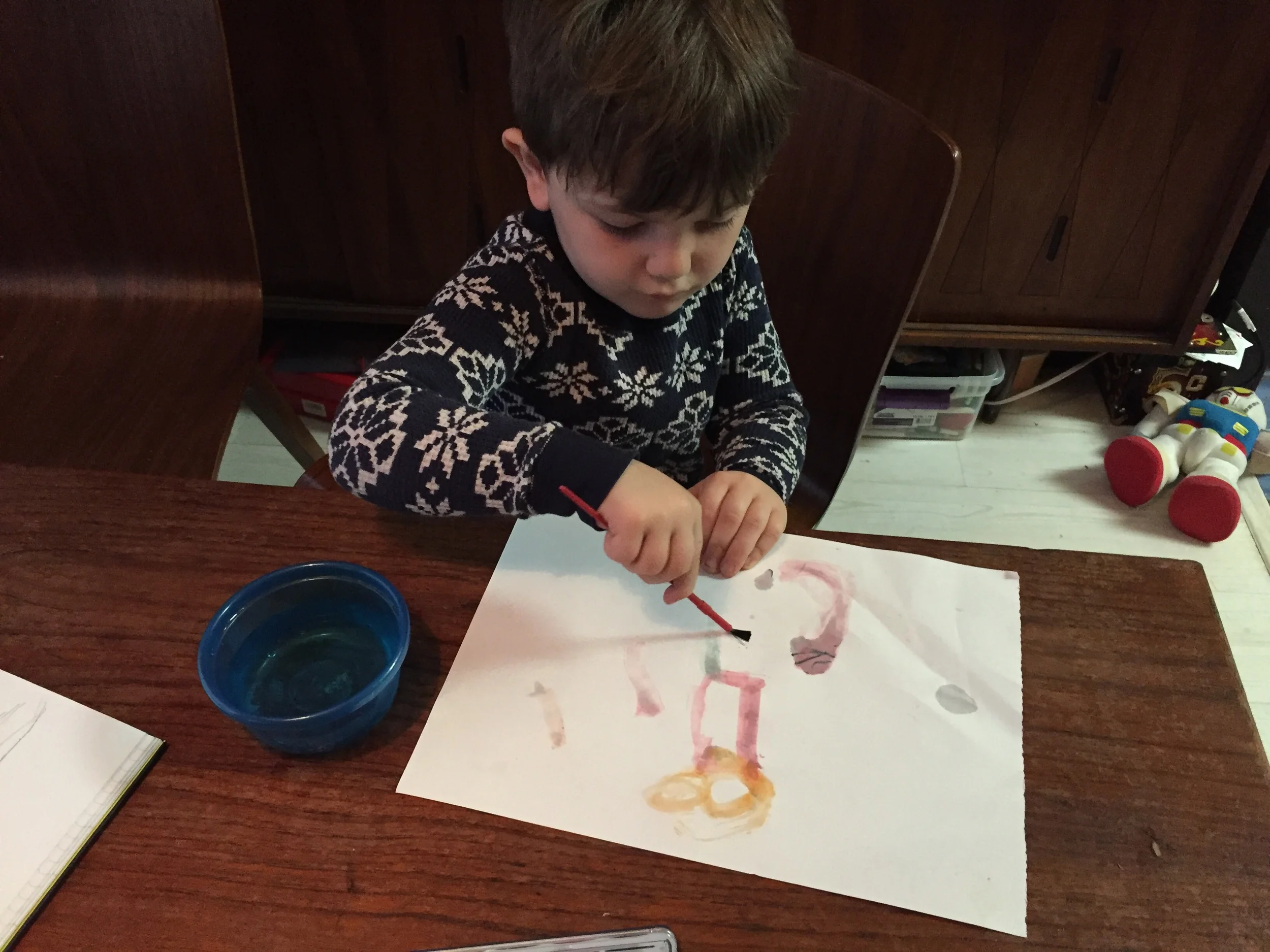 That's him as Robin with Mommy as a superhero. You might have to squint to see it, but it's there.