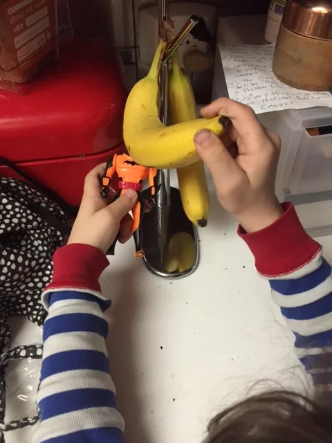 Batman checking the bananas for the next clue