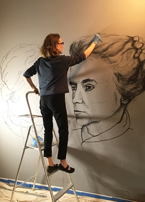 Artist Christine Heller using charcoal to draw two suffragist leaders, Matilda Joslyn Gage (right ) and Louisa Lord Riley (left). This mural was created in September 2017 at The History Center in Tompkins County, Ithaca, NY to celebrate the Centennial of Women’s Right to Vote in New York State. It was part of a show called Truth is the Only Safe Ground to Stand Upon which was also exhibited in 2017 at the Arkell Museum, Canajoharie, NY and the Kubiak Gallery, CANO, Oneonta, NY. Suffragist Louisa Lord Riley was a local Ithaca suffrage organizer and Matilda Joslyn Gage was a New York State leader whose revolutionary theories about women were formed by her close alliance with the matriarchal societies of the Iroquois Confederacy.