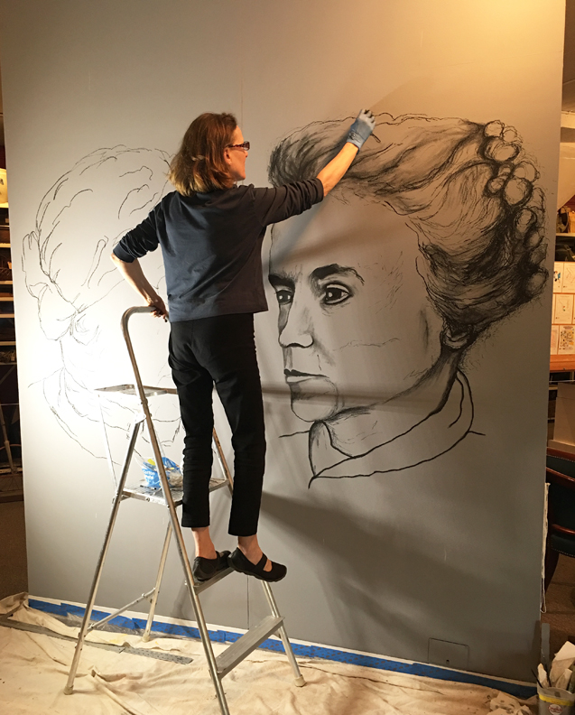 Christine Heller working on mural at The History Center in Ithaca NY