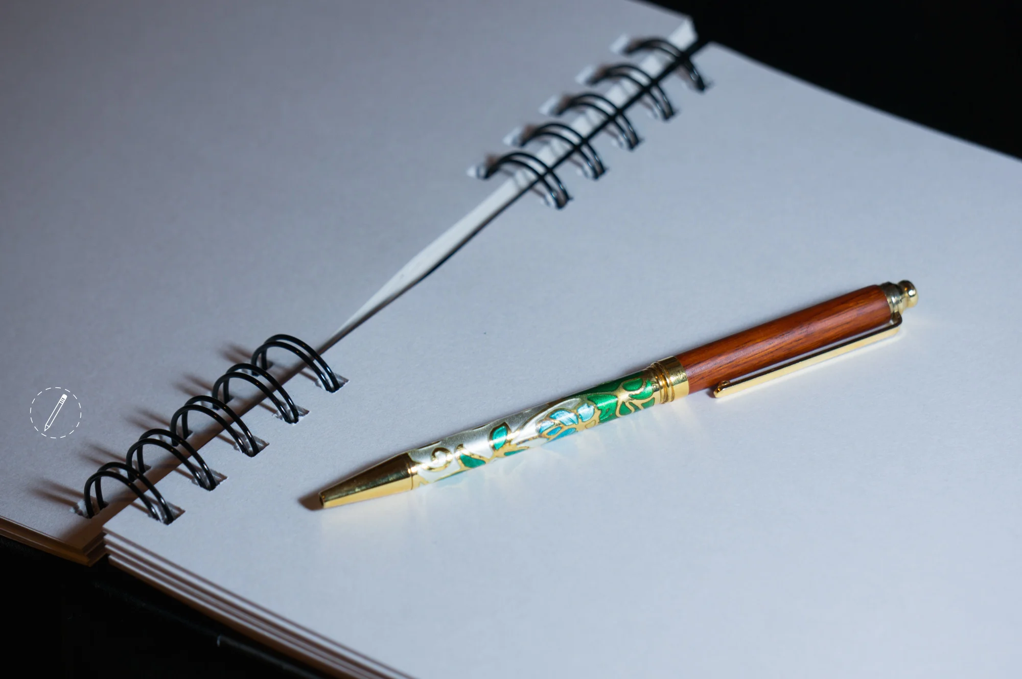 Pen and paper with logo.jpeg