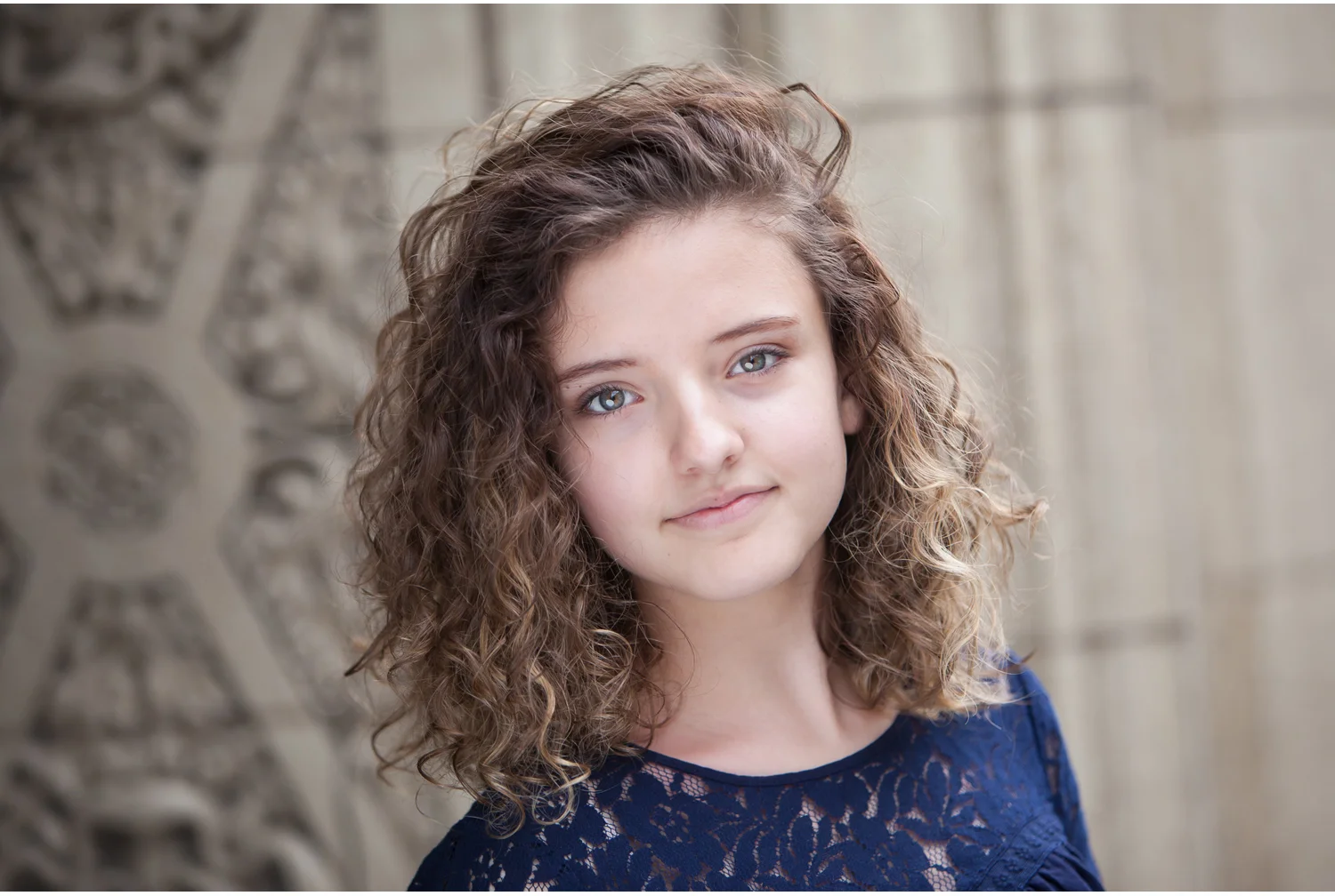 Young woman actor headshots in Denver against vintage building with photographer Jennifer Koskinen, Merritt Portrait Studio