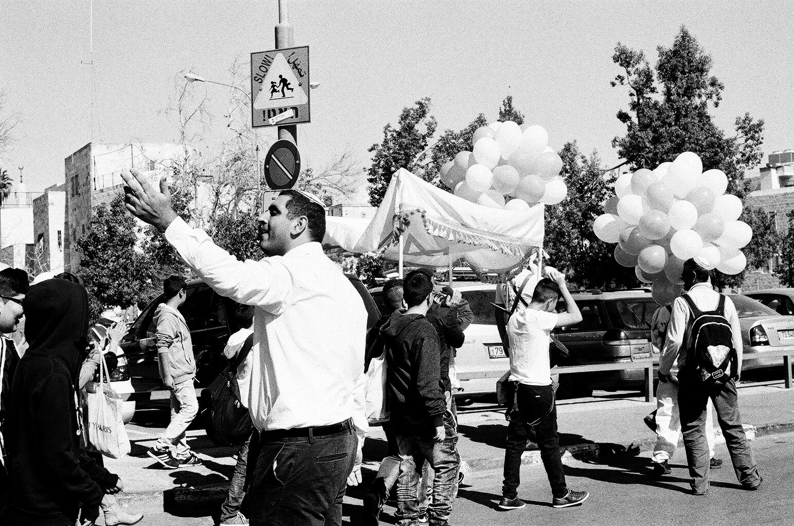 A family celebrating the Bar Mitzvah of their son parades through the Old City celebrating