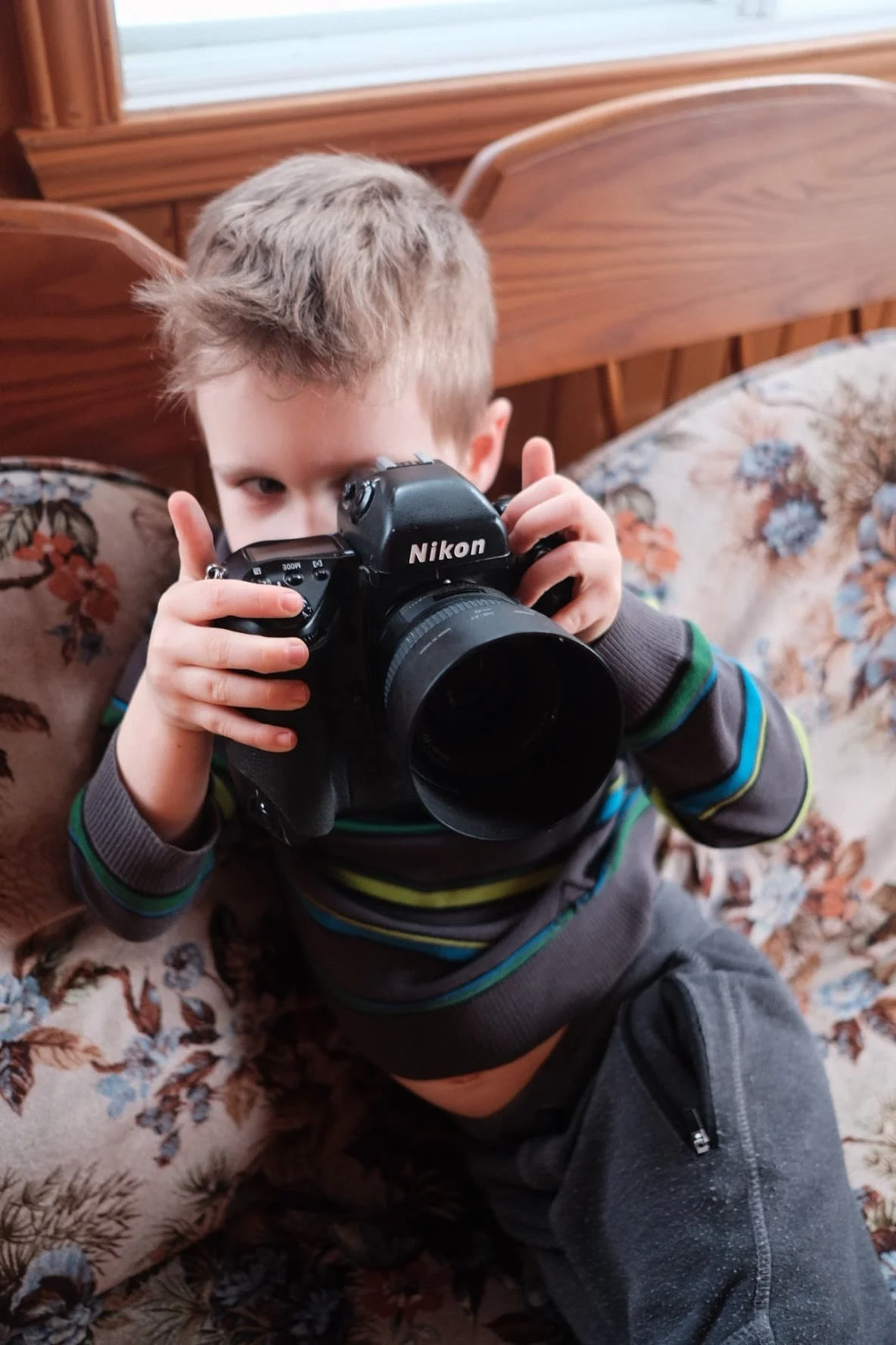 Nephew having fun with the Nikon F5. Taken with the 23mm f/2.0 Fuji wide open.