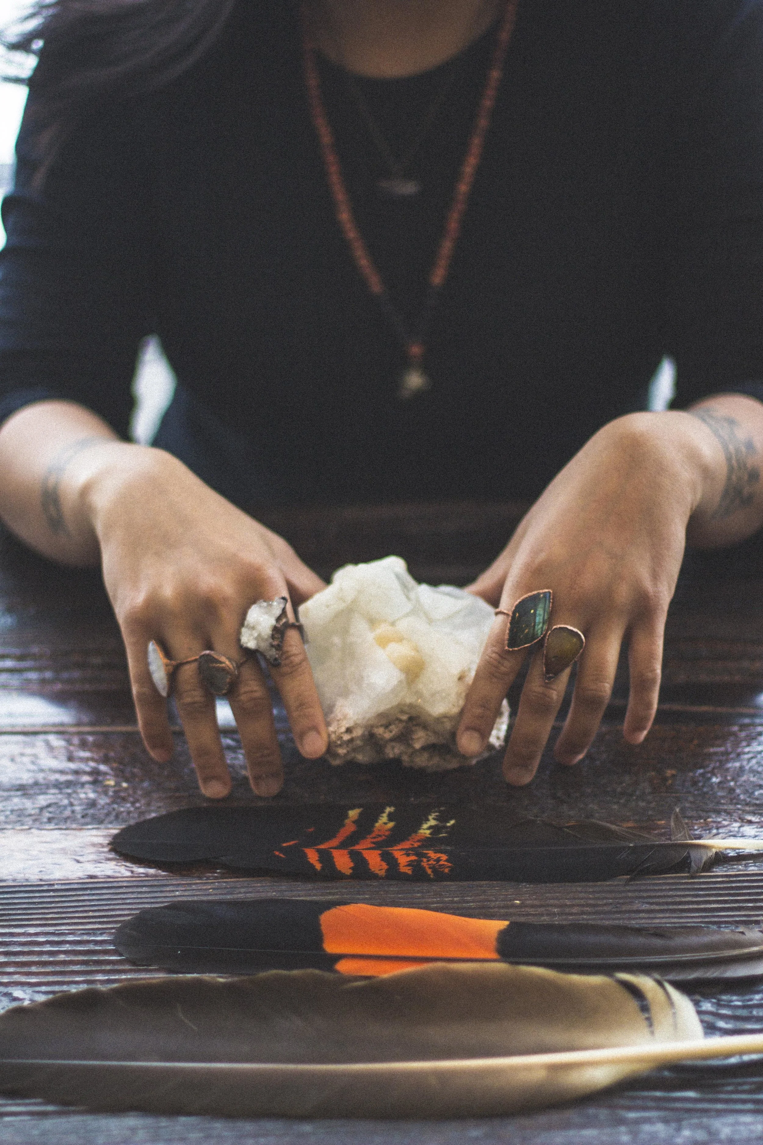 Women with crystal rings holding crystal, bohemian setting