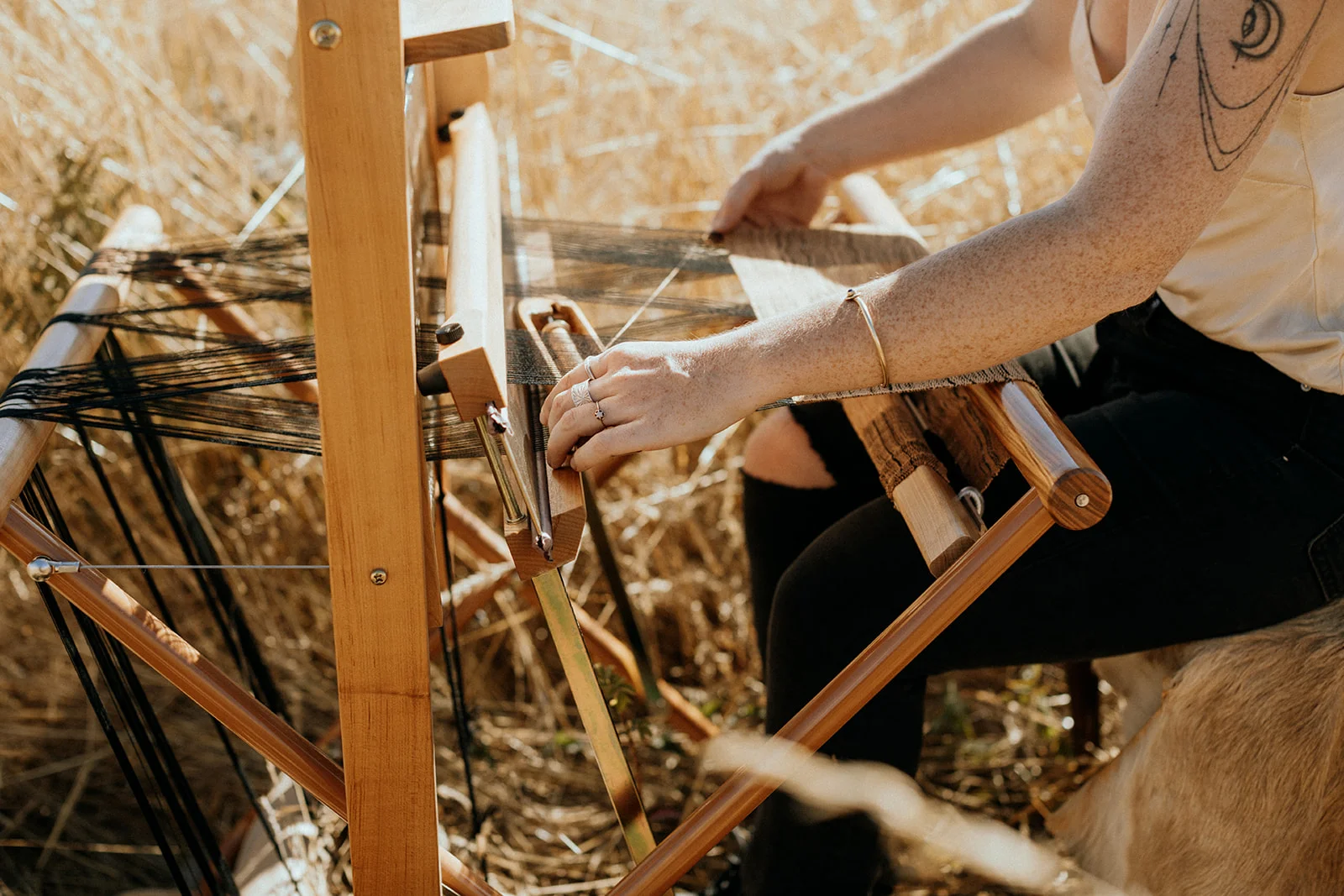 Up close bohemian woman weaving in action