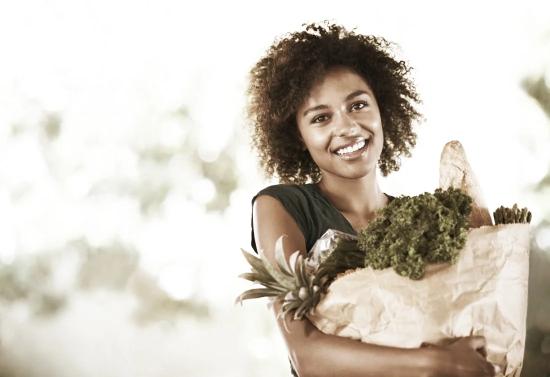 young-woman-carrying-a-brown-bag-of-groceries.jpg