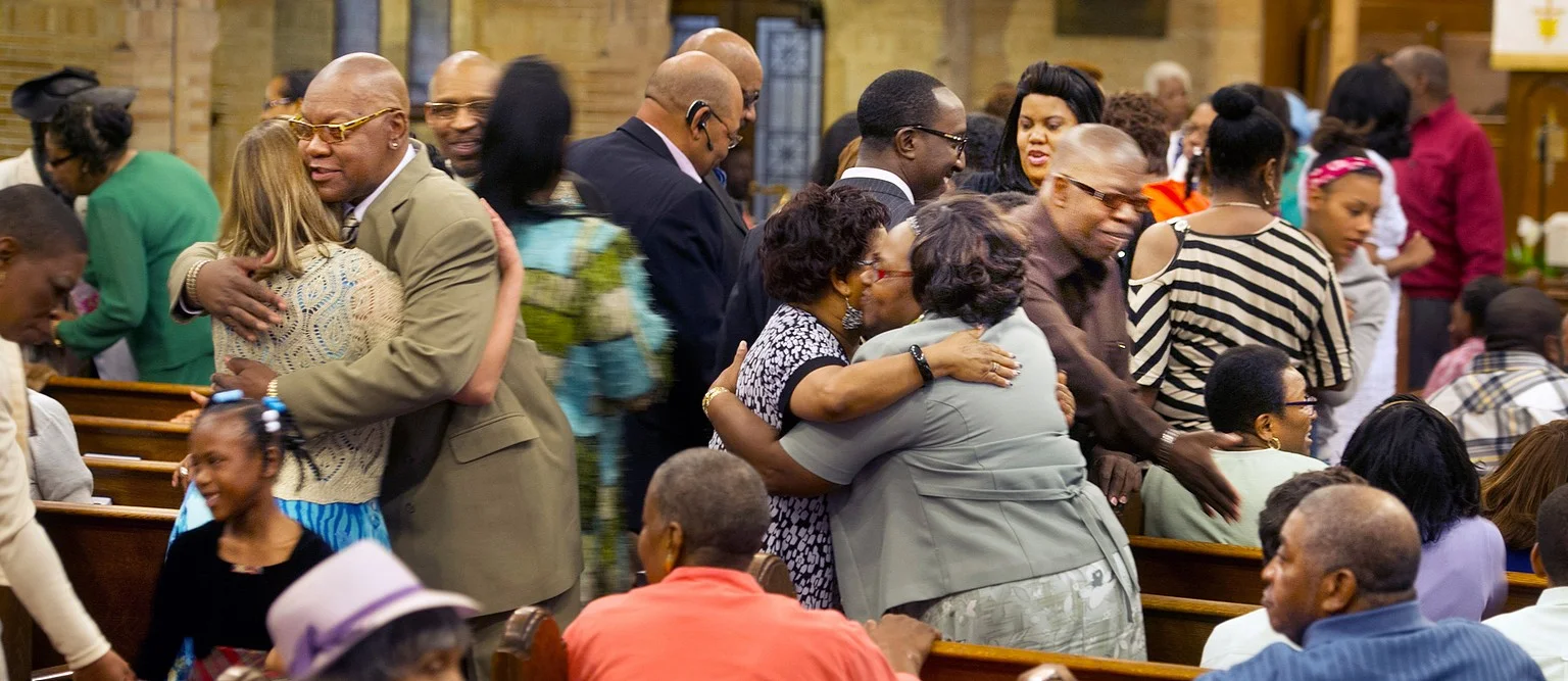 Black church hugging.jpg