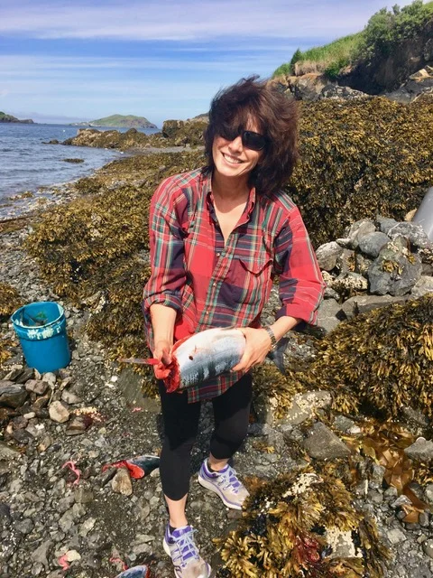 Leslie holding gutted salmon.jpeg