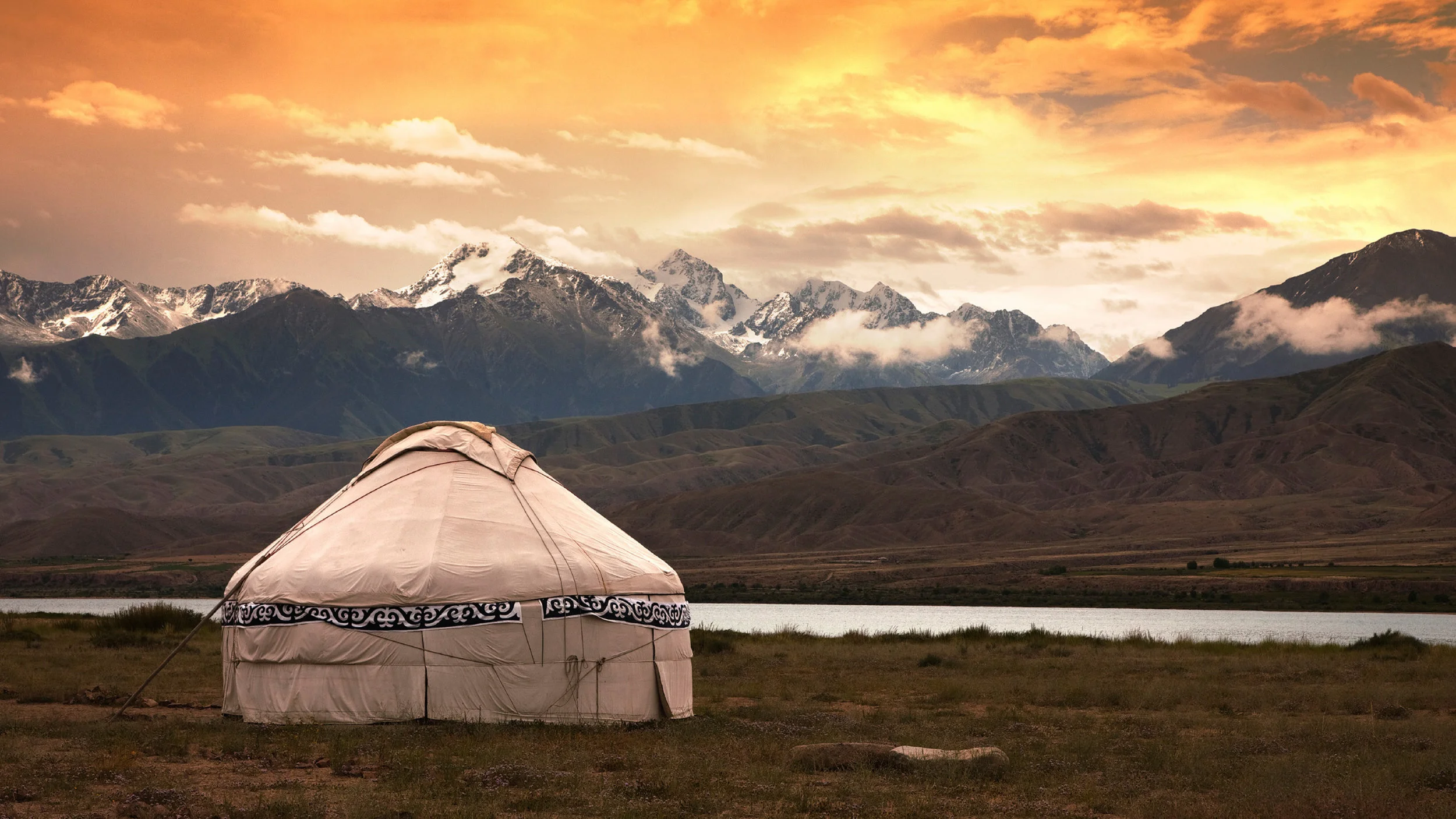 Mongolia--yurt with gorgesou mountains behind.jpg