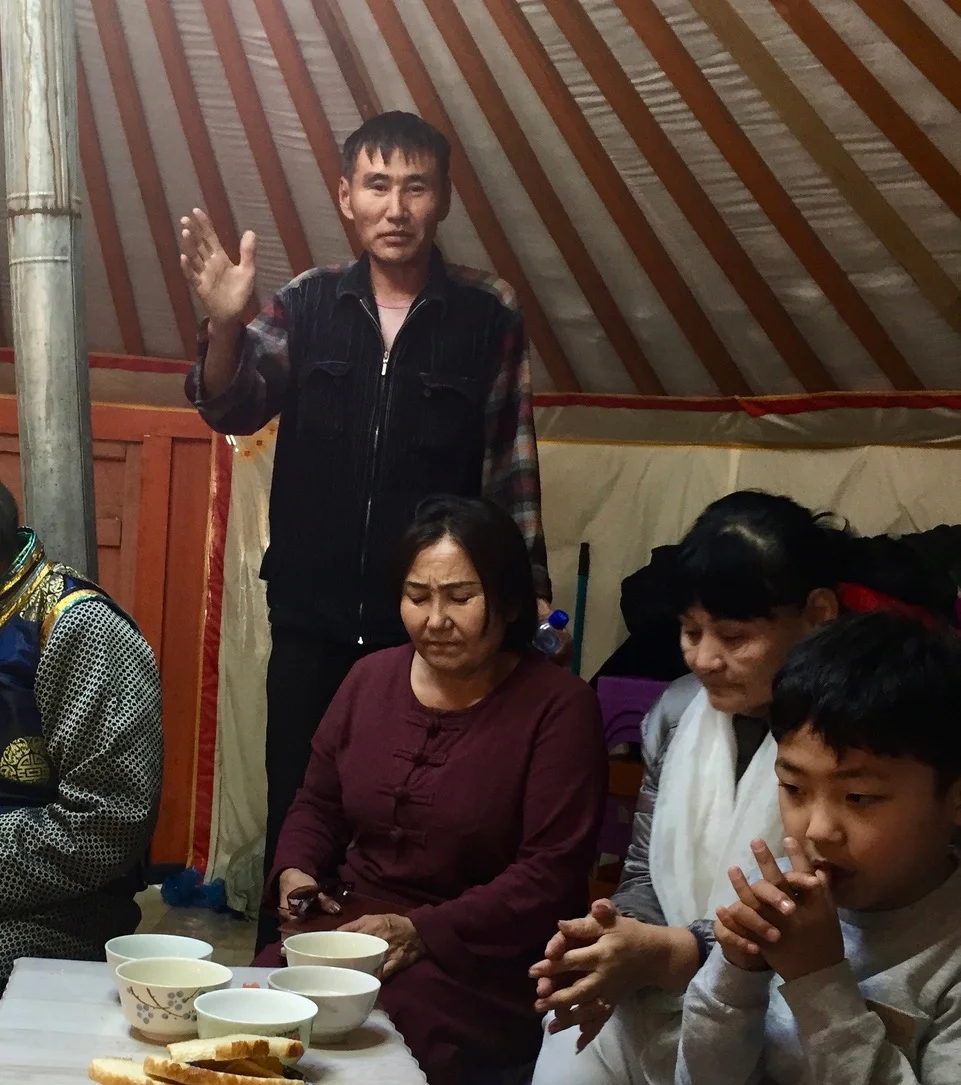Mongolia--man praying with hand up.jpeg